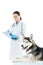 husky and female veterinarian writing diagnosis in clipboard