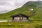 Hut wooden mountain huts in mountain pass Norway. Norwegian landscape with typical scandinavian grass roof houses. Mountain