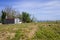 Huts in the countryside in a field of daisies with panoramic views of the Mediterranean sea in the background Marche, Italy