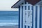 Huts with white and blue strips on the beach