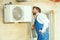 HVAC technician working on a capacitor part for condensing unit