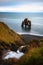 Hvitserkur basalt stack and a small waterfall in northern Iceland