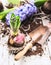 Hyacinth bulbs with roots, soil and old shovel on white wooden garden table