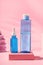 Hyaluronic acid serum and toner bottles on pink background