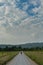 Hyatt Lane and Woman Walking Under Cloudy Sky