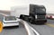 Hybrid electric truck and white electric car on highway