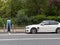 Hybrid electrical vehicle plugged into charging station in Dublin Ireland