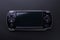 Hybrid handheld portable video game console with switch detachable controllers on both sides isolated on black background