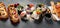 Hybrid trendy food on dark background. Sushi roll pancake, donut sushi, pizza with pasta