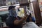 Hyderabad, Telangana, India. june-29-2020: A hairdresser, wearing a protective face mask, works in a barber shop. Reopen after