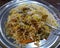 Hyderabadi vegetarian biryani garnished with extra capsicum and spice