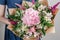 Hydrangea rich bouquet. Vintage floristic background, colorful roses, antique scissors and a rope on an old wooden table