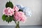 Hydrangeas in a glass vase. Hydrangeas produce larger mopheads made up of clusters of small flowers from Summer through