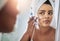 Hydrate your skin with good quality products. Shot of an attractive young woman applying moisturizer to her face in the