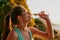 Hydration is an important part of running. an attractive young woman getting a drink during her workout.