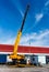 Hydraulic crane beams against blue sky