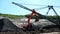 Hydraulic crane works in quarry with sand fraction