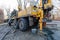 Hydraulic ground water hole drilling machine installed on the old truck with big wheels on the construction site. Groundwater well