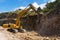 Hydraulic hammer destroys rock in road construction