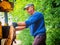 Hydraulic log splitting machine attached to a tractor the machine is being used to split large wooden logs