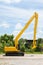 Hydraulic Yellow Excavator side view on outdoor location.