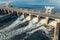 Hydroelectric dam or hydro power station at water reservoir, aerial view from drone. Draining water through gate