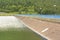 Hydroelectric power dam lined with blue railings and lamps