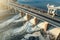 Hydroelectricity power station gates with flowing water, aerial view