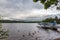 Hydroplane, ducks and dramatic cloudscape- lake shore in Loch