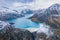 Hydropower generated from arch dam and reservoir lake in snow covered Swiss Alps mountains to produce renewable energy,