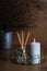 hygge and aromatherapy concept - candles and aroma diffuser on table at home
