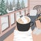 Hygge card of winter vibes and person in warm sweater enjoying moment with mug and hot drink.