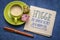hygge - the Danish secret to a happy life, handwritten note on a napkin with a cup of coffee