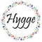 Hygge sign symbolizing Danish Life style surrounded by colorful spring inspired circle surrounded by flowers, leaves, butterflies