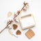 Hygge toys flat lay. Wooden waffles, waffle maker, toast, knife and spatula with blooming cotton branch on white background