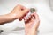 Hygiene. Close-up view of a young girl washing her hands with soap and a brush. A woman washes her hands in the sink to get rid of