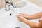 Hygiene concept. Washing hands with soap under the faucet with water