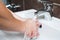 Hygiene concept. Washing hands with soap under the faucet with water