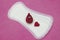 Hygiene conception photo. Menstruation sanitary soft pad for woman hygiene protection, crochet red heart, crochet funny blood drop