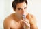 Hygiene - Handsome young guy brushing his teeth. Portrait of a young masculine man brushing his teeth.