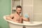 hygiene and health. Morning shower. desire and temptation. macho man washing in bath. man wash muscular body with foam