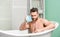 Hygiene and health. Morning shower. man wash muscular body with foam sponge. macho man washing in bath. desire and