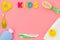 Hygiene items for the child. Bath accessories with yellow rubber duck on pink background top view copy space frame. Word