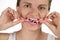 Hygiene of the oral cavity. Young girl cleans teeth with floss,