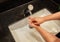 Hygiene ,Sanitation concept. woman is washing his hands in a sink sanitising the corona virus for sanitation and reducing the