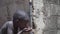 Hygiene symbol, little African black boy drinking fresh water from tap in Bamako, Mali