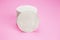 Hygienic cotton pads stacked on a pink background