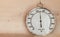 Hygrometer hanging on wooden wall, close-up