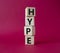 Hype symbol. Concept word Hype on wooden cubes. Beautiful red background. Business and Hype concept. Copy space