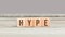 Hype word on wood cube dices on aged table